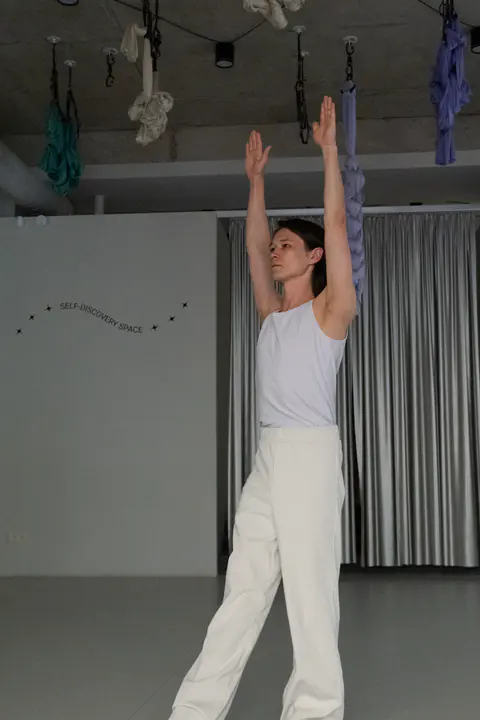 A first-timer standing with her arms raised