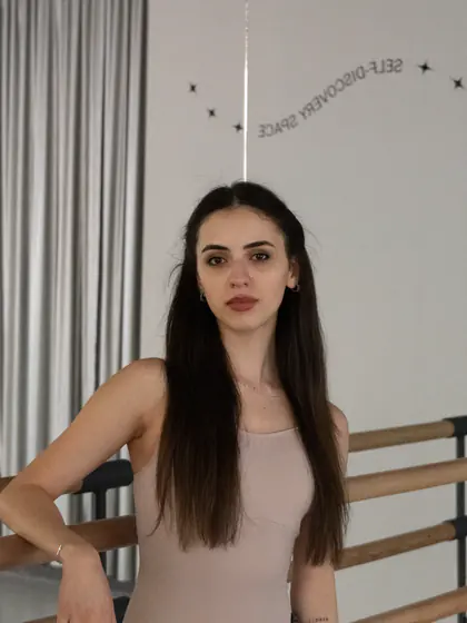 A student standing by the barre