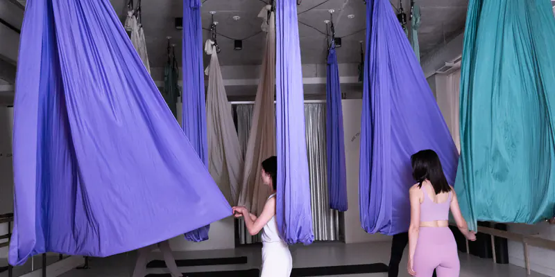 Lilac and teal silks hanging in the studio's main room
